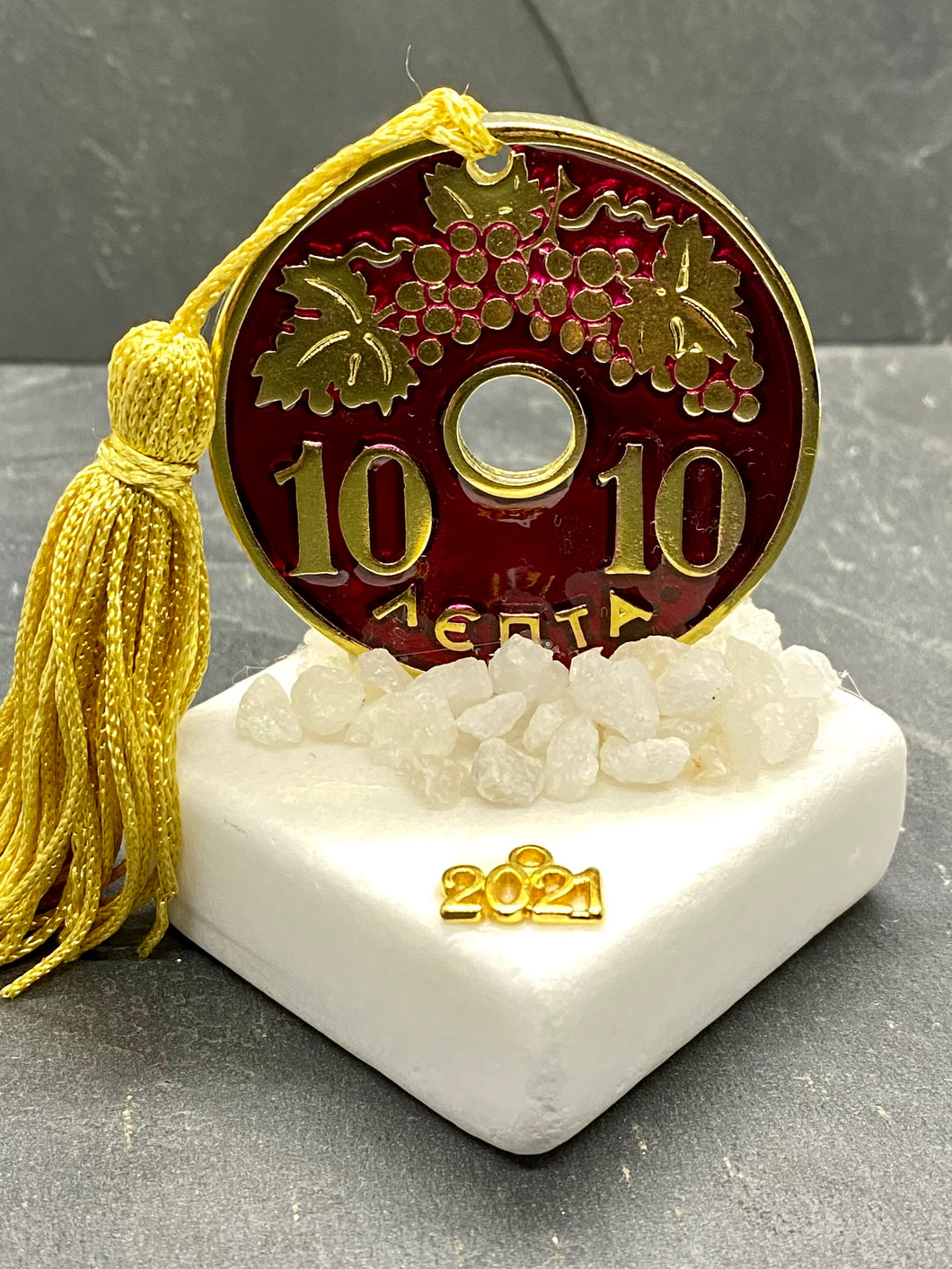 Table Top 20 Lepta Coin on Marble with marble pebbles and Tassel
