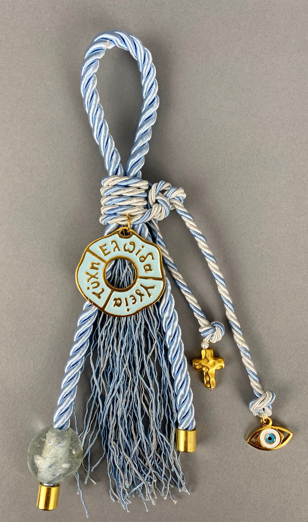 Gouri 1011 Pearl Baby Blue Cord Gouri, large Metal  Hope Health Luck, large Murano Glass Bead., metal Cross and Mati charms.  Measures 9” in length.