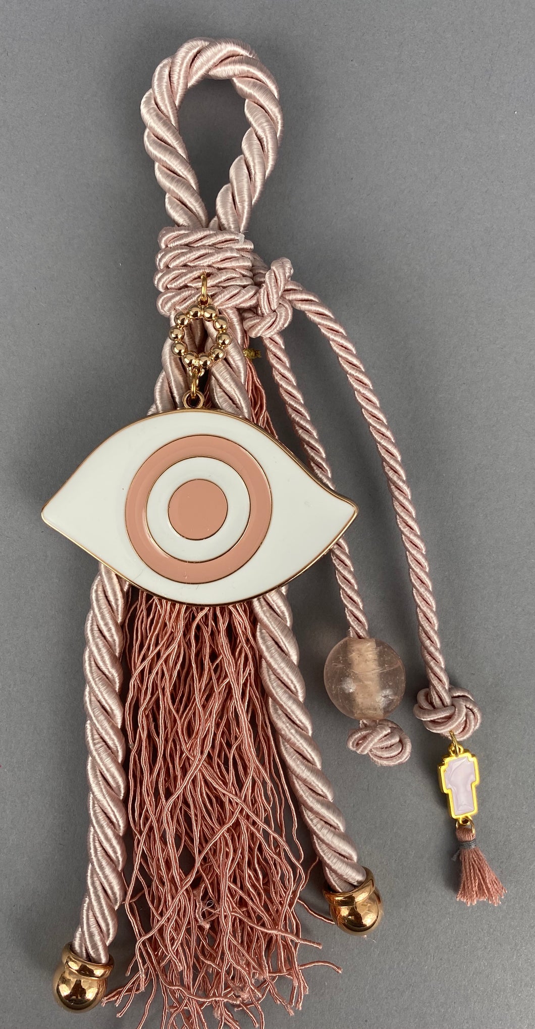 Gouri 1009 Pearl Baby Pink Cord Gouri, large Metal  Mati, large Murano Glass Bead, metal cross charm and extra long Tassel.  Measures 9” in length.